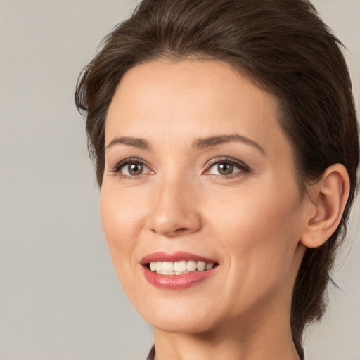 Joyful white young-adult female with medium  brown hair and brown eyes