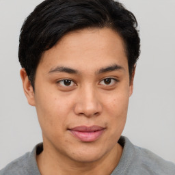 Joyful latino young-adult male with short  brown hair and brown eyes