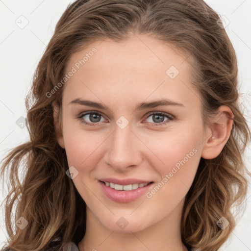 Joyful white young-adult female with long  brown hair and blue eyes