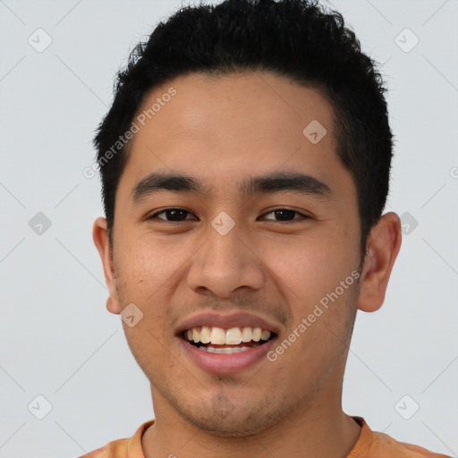 Joyful latino young-adult male with short  brown hair and brown eyes