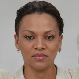 Joyful black adult female with short  brown hair and brown eyes