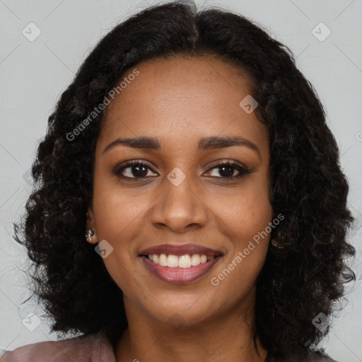 Joyful black young-adult female with long  black hair and brown eyes