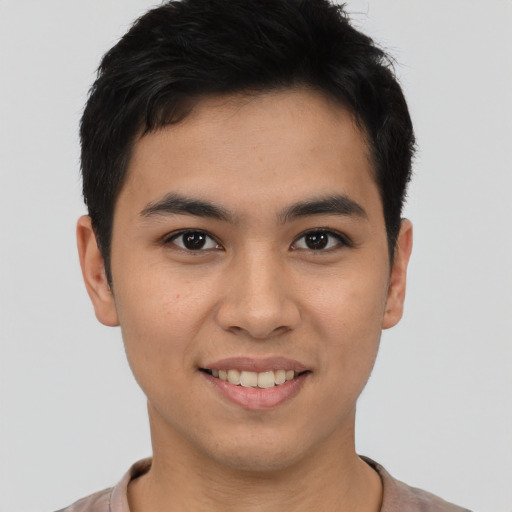 Joyful asian young-adult male with short  brown hair and brown eyes