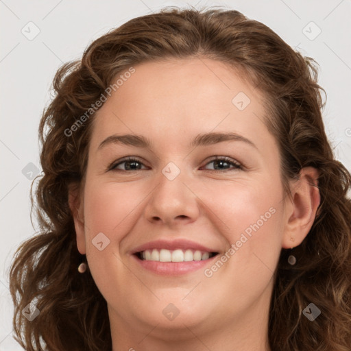 Joyful white young-adult female with long  brown hair and green eyes