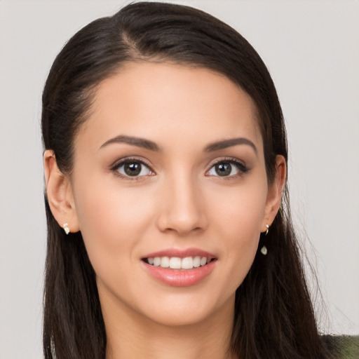 Joyful white young-adult female with long  brown hair and brown eyes