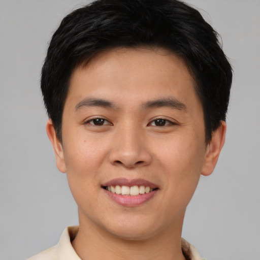 Joyful asian young-adult male with short  brown hair and brown eyes