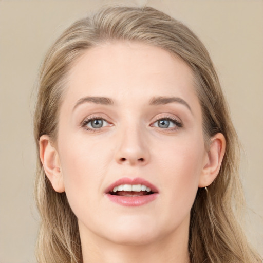 Joyful white young-adult female with long  brown hair and blue eyes