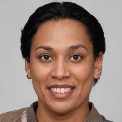 Joyful latino adult female with short  black hair and brown eyes