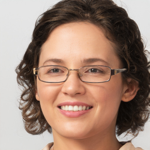 Joyful white adult female with medium  brown hair and green eyes