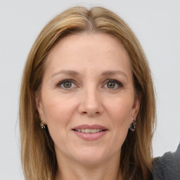 Joyful white adult female with long  brown hair and grey eyes