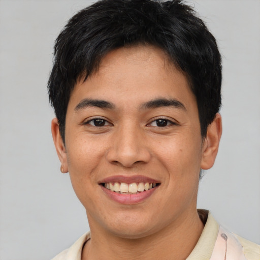 Joyful asian young-adult male with short  black hair and brown eyes