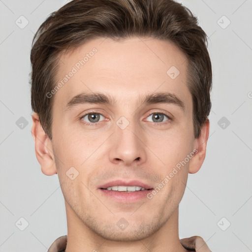 Joyful white young-adult male with short  brown hair and grey eyes