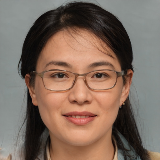 Joyful white adult female with medium  brown hair and brown eyes