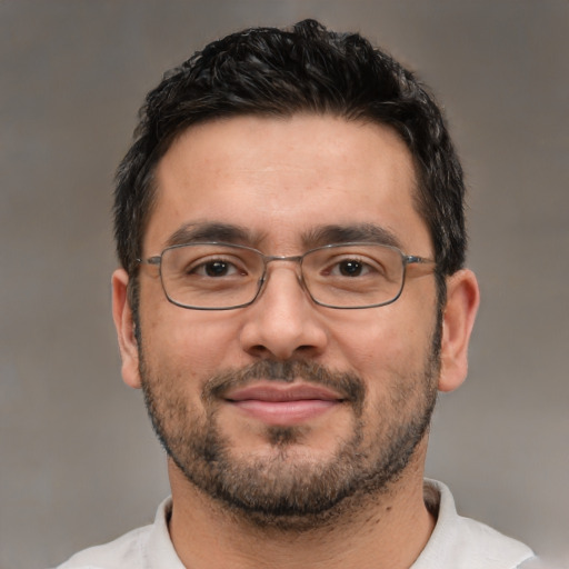 Joyful white adult male with short  black hair and brown eyes