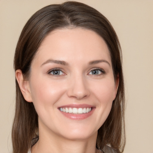 Joyful white young-adult female with medium  brown hair and grey eyes