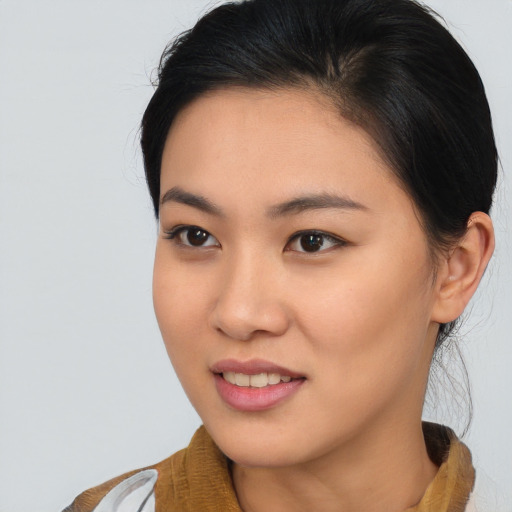 Joyful asian young-adult female with medium  brown hair and brown eyes