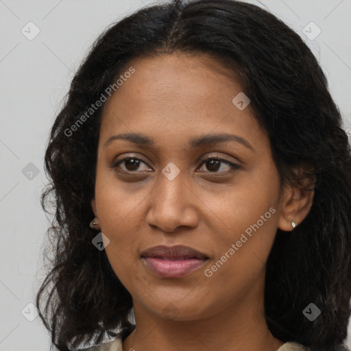 Joyful black young-adult female with long  brown hair and brown eyes