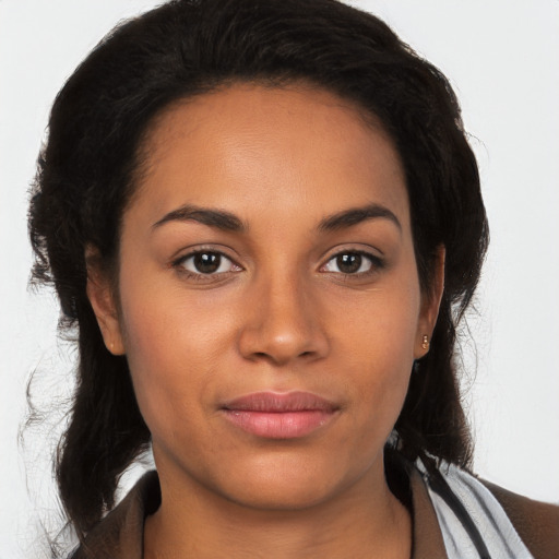 Joyful latino young-adult female with long  brown hair and brown eyes