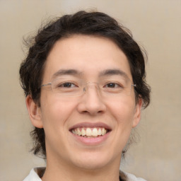 Joyful white adult male with medium  brown hair and brown eyes