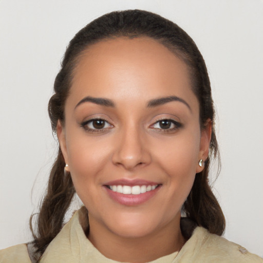 Joyful latino young-adult female with long  brown hair and brown eyes