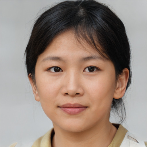 Joyful asian young-adult female with medium  brown hair and brown eyes