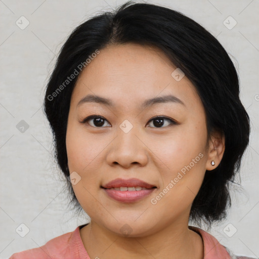 Joyful asian young-adult female with medium  black hair and brown eyes