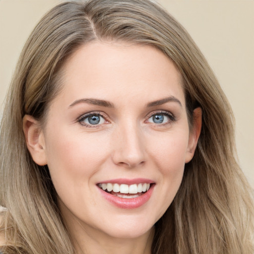 Joyful white young-adult female with long  brown hair and blue eyes