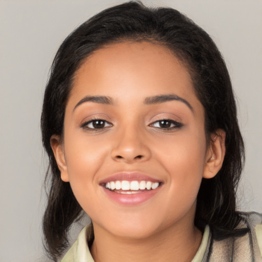 Joyful latino young-adult female with medium  black hair and brown eyes