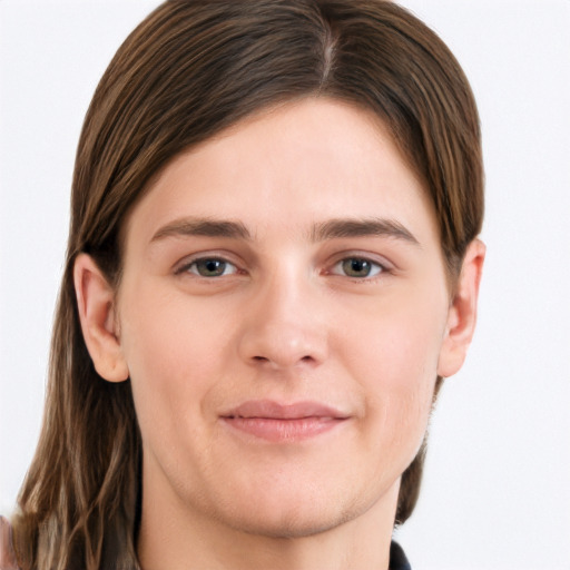 Joyful white young-adult male with long  brown hair and brown eyes