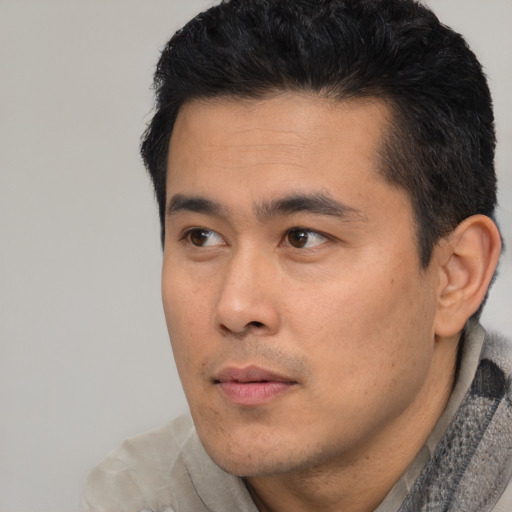 Neutral latino young-adult male with short  black hair and brown eyes