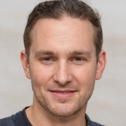 Joyful white adult male with short  brown hair and grey eyes