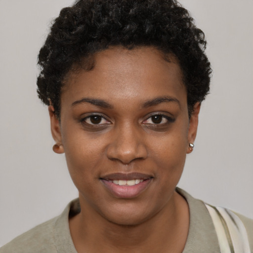 Joyful black young-adult female with short  brown hair and brown eyes