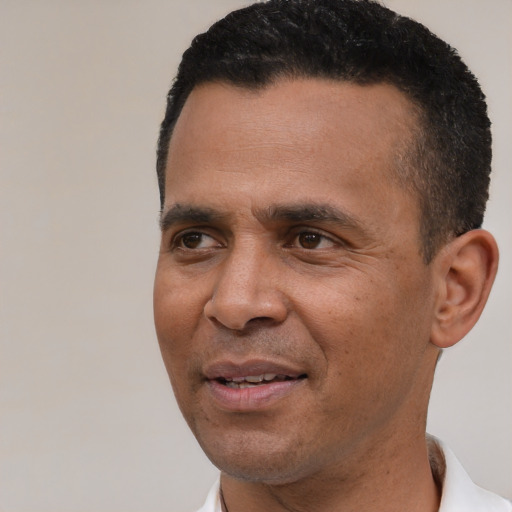 Joyful black adult male with short  black hair and brown eyes
