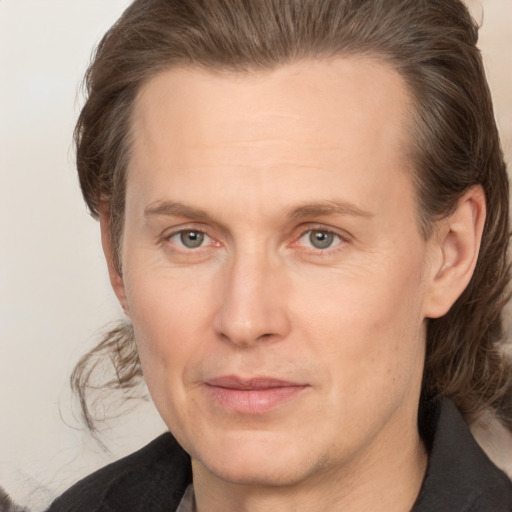 Joyful white adult male with medium  brown hair and grey eyes