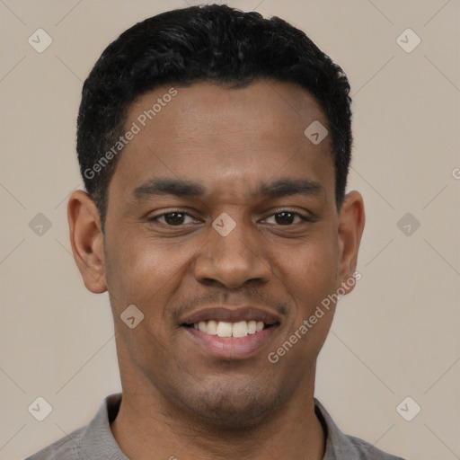 Joyful black young-adult male with short  black hair and brown eyes