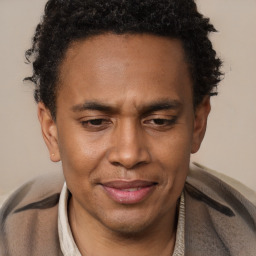 Joyful black adult male with short  brown hair and brown eyes