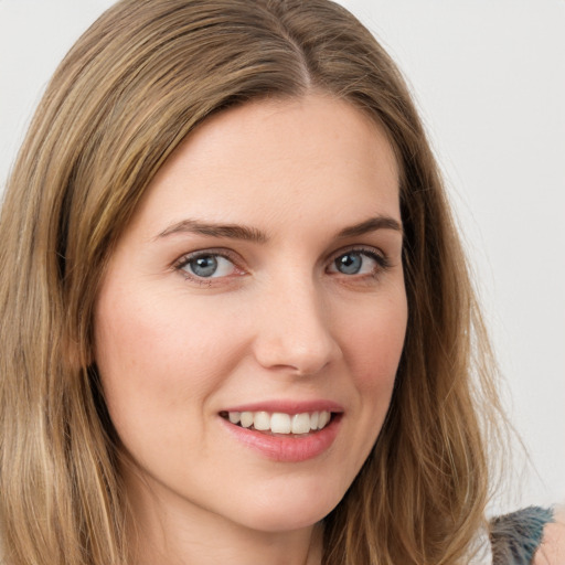 Joyful white young-adult female with long  brown hair and green eyes