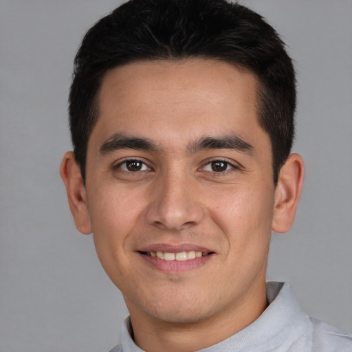 Joyful white young-adult male with short  black hair and brown eyes