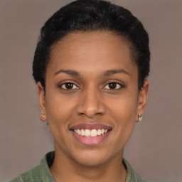 Joyful latino young-adult female with short  brown hair and brown eyes