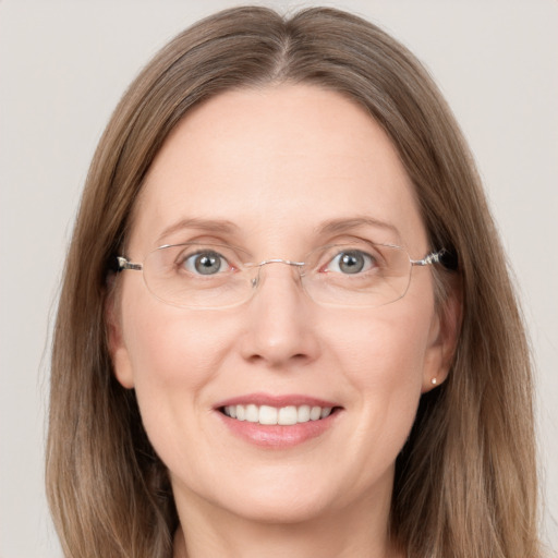 Joyful white adult female with long  brown hair and grey eyes