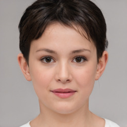 Joyful white child female with short  brown hair and brown eyes