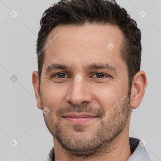 Joyful white young-adult male with short  brown hair and brown eyes