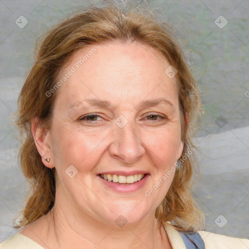 Joyful white adult female with medium  brown hair and blue eyes