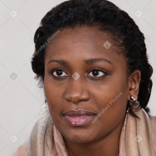 Joyful black young-adult female with long  brown hair and brown eyes