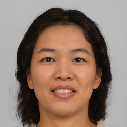 Joyful asian young-adult female with medium  brown hair and brown eyes