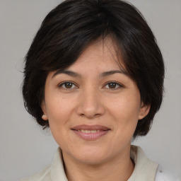 Joyful white adult female with medium  brown hair and brown eyes