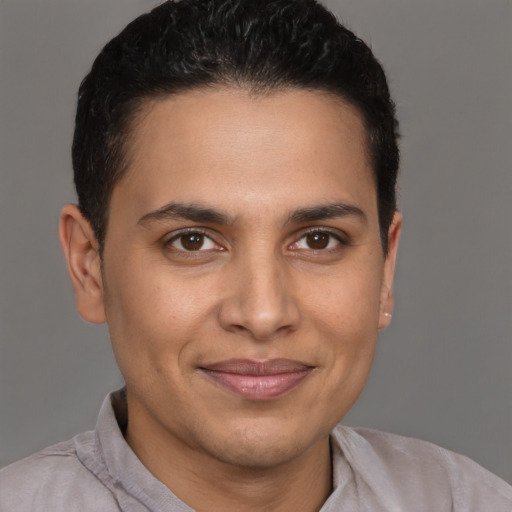 Joyful latino young-adult male with short  brown hair and brown eyes