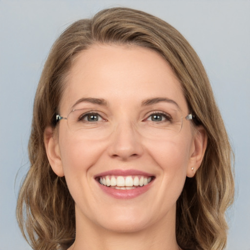 Joyful white adult female with medium  brown hair and grey eyes