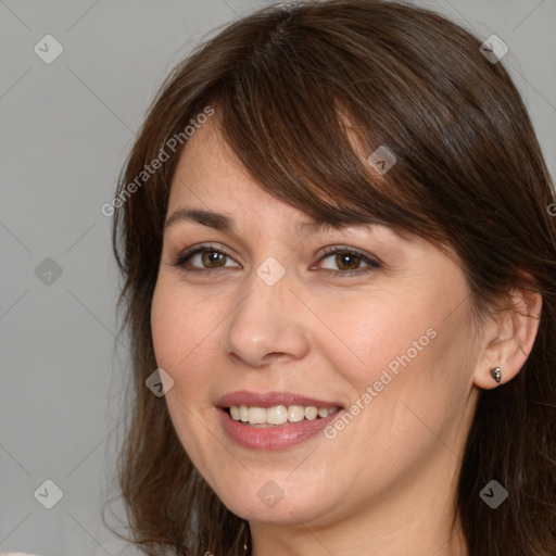 Joyful white young-adult female with medium  brown hair and grey eyes