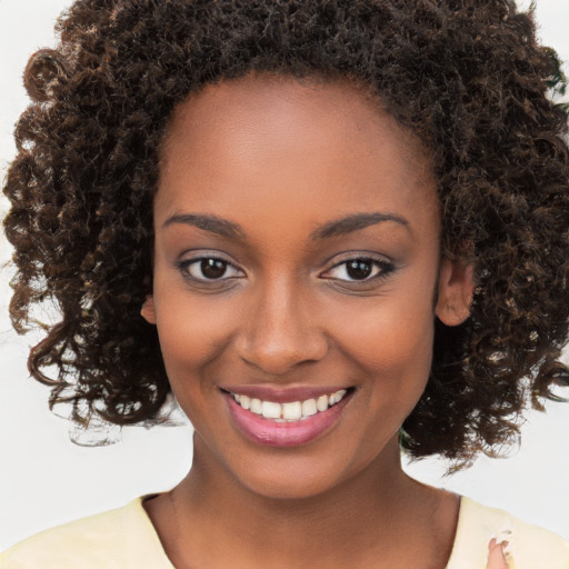 Joyful black young-adult female with medium  brown hair and brown eyes